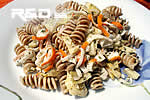 Rotini pasta salad dressed with artichokes and fish