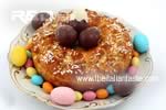 leavened cake garnished with decorating sugars and chocolate eggs