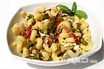 Short pasta topped with salami and asparagus