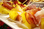 Skewers with baby pineapple and speck ham
