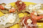 Sage canapes garnished with prawns, ham, quail eggs and mozzrella