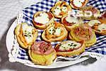 Italian crostini topped with salami, salmon and pancetta