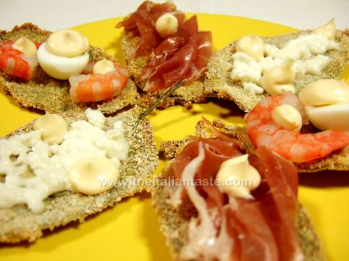 Quail eggs, raw ham, mozzarella and prawns on breaded sage leaves