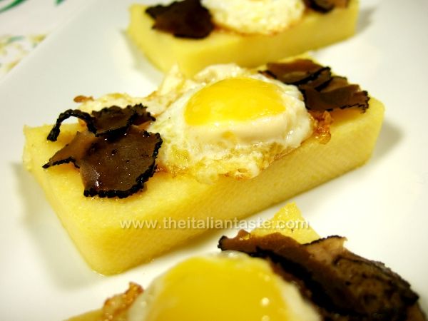 Quail eggsss and black truffle on polenta slices